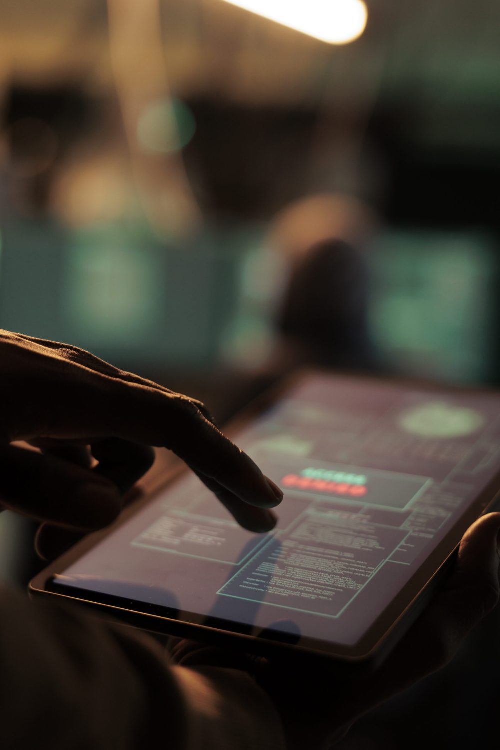 African american hacker holding tablet to hack online system, causing malware on network and planning cyberattack. Looking at security server to access database and steal passwords.